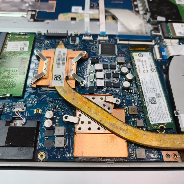 HP laptop motherboard heatsink M.2 SSD closeup