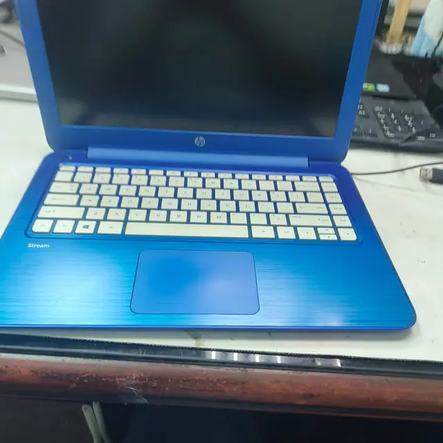 HP Stream blue laptop keyboard touchpad closeup