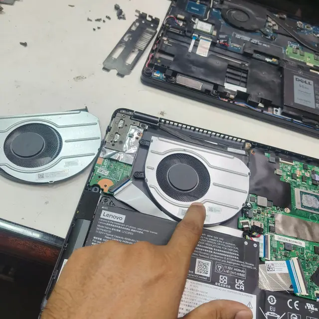 Lenovo laptop old cooling fan removed next to new fan installation