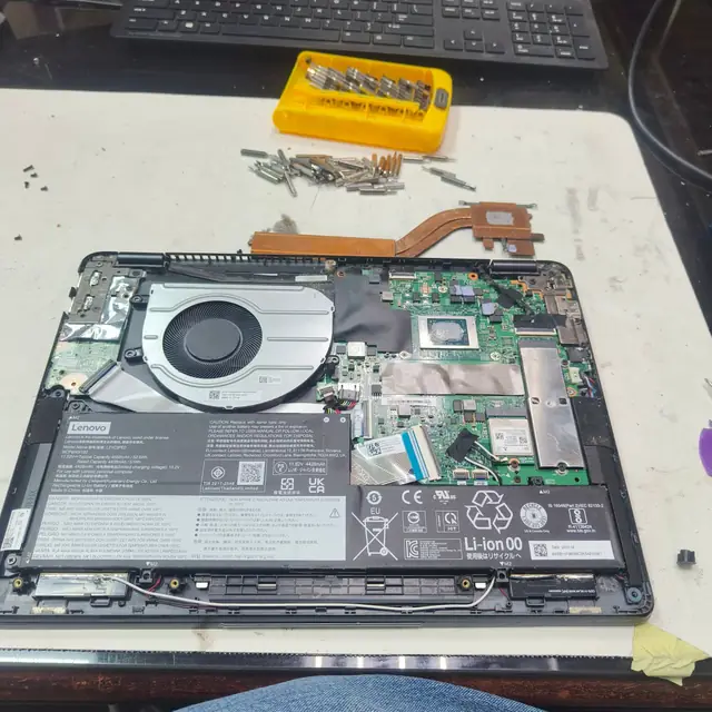 Lenovo laptop opened cooling fan and heatsink removed for cleaning