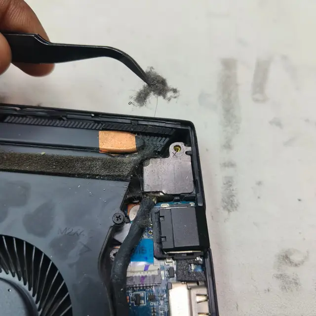 Removing dust lint gaming laptop heatsink tweezers